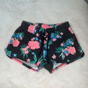 Size 8 floraled cotton justice shorts, with crossed laces at the top.